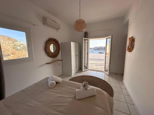 a bedroom with a bed and a view of the ocean at Revel Mykonos 3 in Ornos
