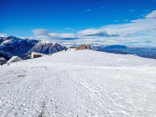 a snow covered hill with a building on top of it at Apartment Tenuta Rucas by Interhome in Montoso