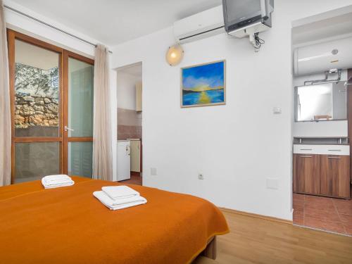 a room with a bed with two towels on it at Apartment Cico-2 by Interhome in Gdinj