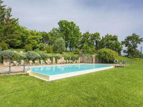 a swimming pool in the yard of a house at Apartment Il Melo by Interhome in Grassina