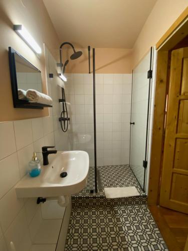 a bathroom with a sink and a shower at Katalinkert Panzió in Győr
