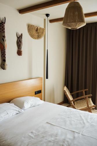 a bedroom with a bed and a chair and lamps at The May Five - Adults only in Seferihisar
