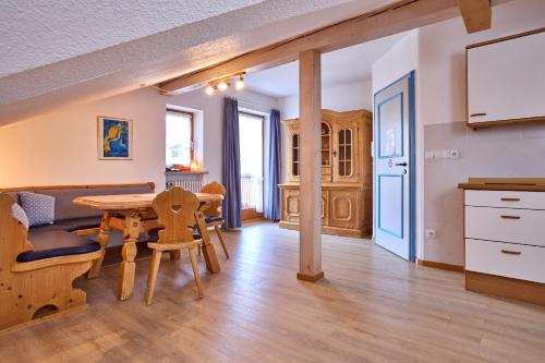 a kitchen and dining room with a table and chairs at Hotel Antonia in Oberammergau