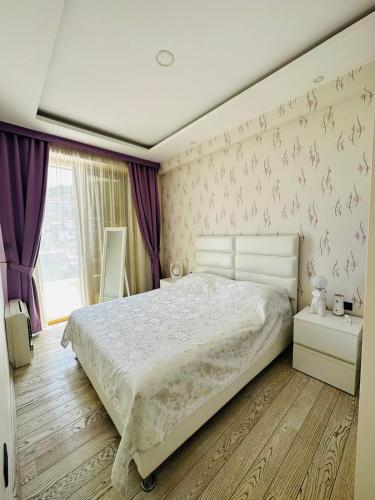 Ένα ή περισσότερα κρεβάτια σε δωμάτιο στο Laura Apartman