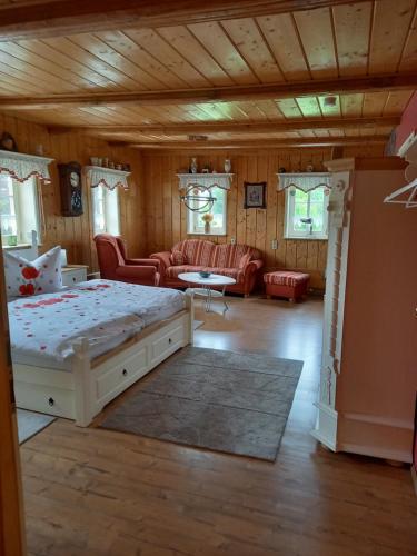 a bedroom with a bed and a living room at Pension Spreeeck in Habrachćicy
