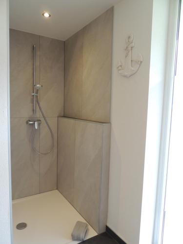 a bathroom with a shower with a glass door at Bacher´s Home am Sonnenplateau in Mieming