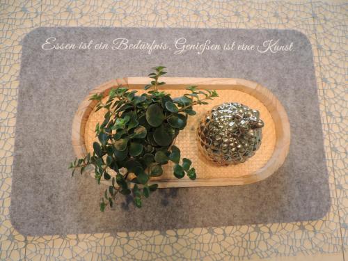 a potted plant sitting on a cutting board with at Bacher´s Home am Sonnenplateau in Mieming