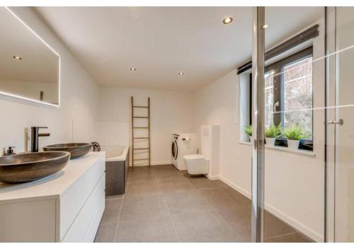 a bathroom with a sink and a toilet at The Heart of Leuven in Leuven