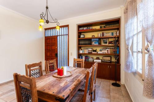 a dining room with a wooden table and chairs at Avia's Seaside Hideaway with Lush Garden in Avia