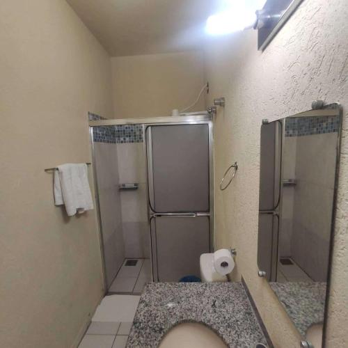 a bathroom with a shower stall and a toilet at Hotel Lago Azul in Bonito