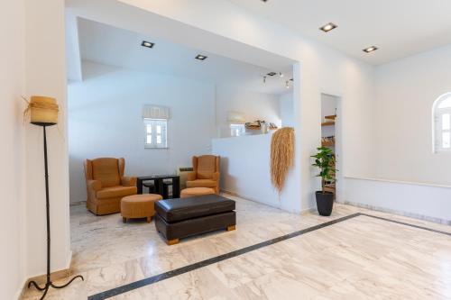a living room with a couch and chairs at Agrilia Hotel Adults Only in Laganas