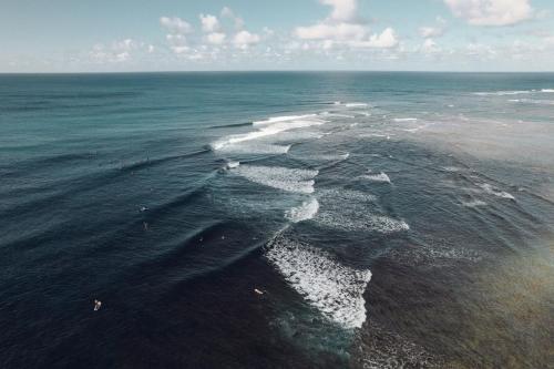an aerial view of the ocean with waves at Banyan Harbor Resort in Lihue