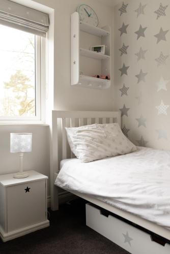 a bedroom with a bed with stars on the wall at The Luxury House in Swanland