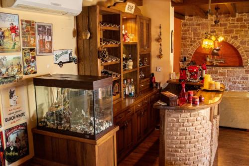 a room with a fish tank in a room at Luxury House with huge garden - Near "Mavra Volia" Beach in Emporeiós