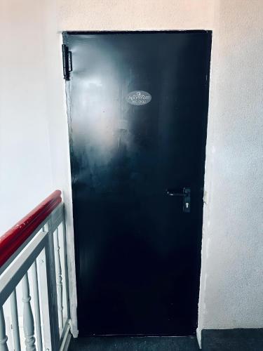 a black door with a sticker on the side of a building at Wohnen im Turm Genialer Schlossblick in Steinfurt
