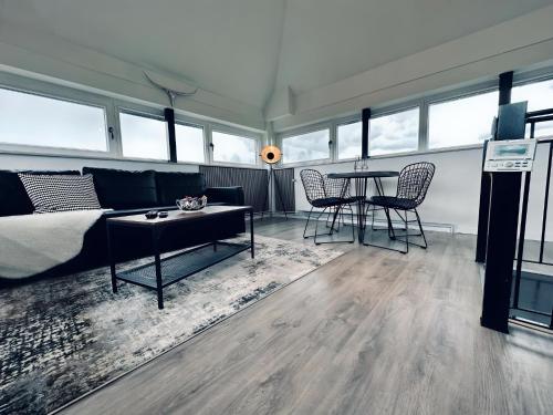 a living room with a couch and a table at Wohnen im Turm Genialer Schlossblick in Steinfurt