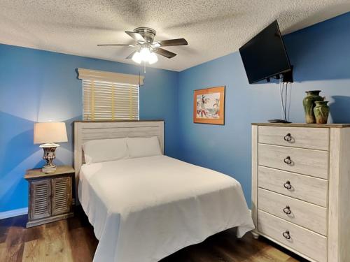 a bedroom with a bed and a ceiling fan at Royal Palms 1103 in Gulf Shores