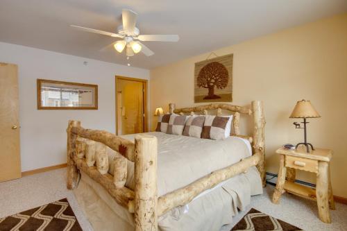 a bedroom with a wooden bed and a ceiling fan at Condo in Cedar Creek with Shuttle to Big Sky Resort! in Gallatin Gateway