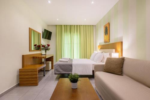 a hotel room with a bed and a couch at Agrilia Hotel Adults Only in Laganas