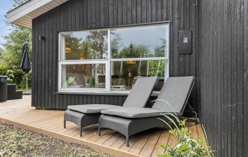 two chairs on a deck next to a house at Stunning Home In Sæby With Wifi in Sæby