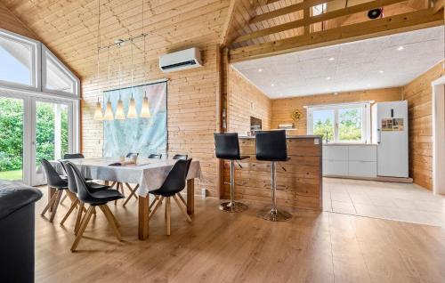 a kitchen and dining room with a table and chairs at Three-Bedroom Holiday Home In Hemmet in Hemmet