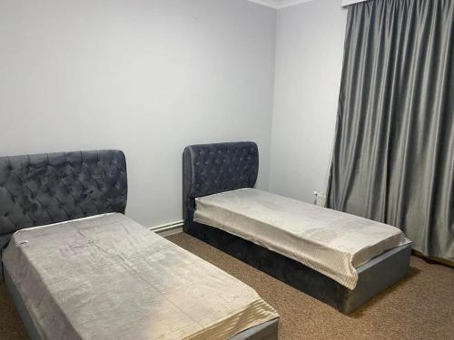 a room with two beds and a window at Comfort House in Akhalk'alak'i