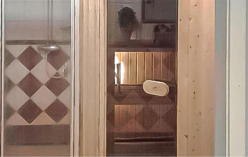 a close up of a glass door of a room at Nice Home In Överkalix With Sauna in Överkalix
