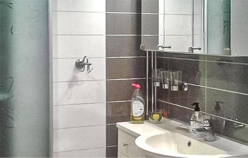 a bathroom with a sink and a mirror at Nice Home In Överkalix With Sauna in Överkalix