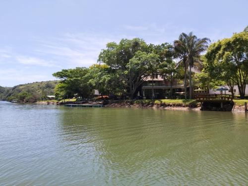 a body of water with trees in the background at Areena Riverside Resort in Kwelera