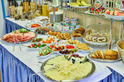 a table with many plates of food on it at Hotel Antonia in Oberammergau