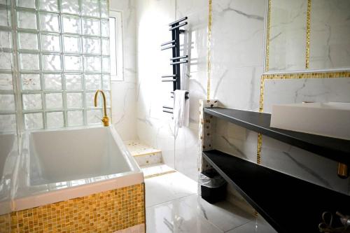 une salle de bain avec une baignoire et un lavabo dans l'établissement le lenn La Maison Du Lenn Exceptional location, à Louannec