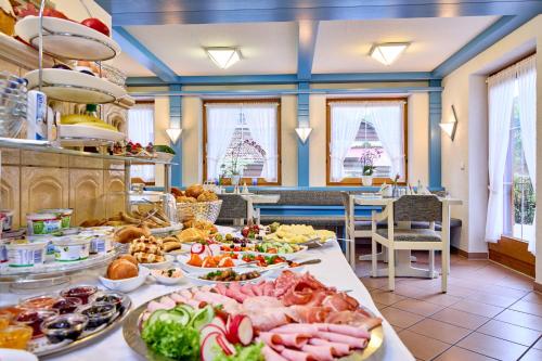 a buffet with many plates of food on a table at Hotel Antonia in Oberammergau