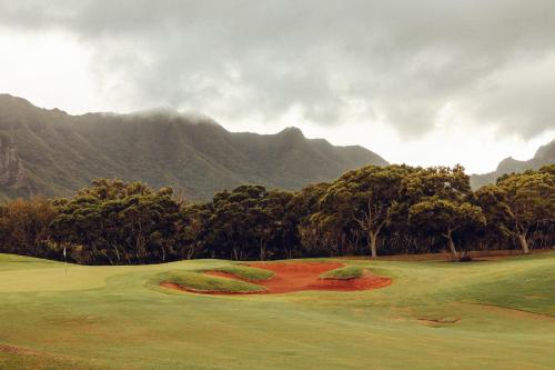 a view of a golf course with mountains in the background at Banyan Harbor Resort in Lihue