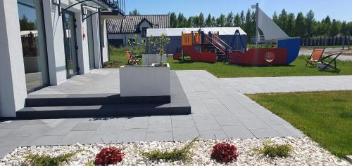 a park with a playground with at Bursztynowa Rosa & Wypożyczalnia rowerów elektrycznych in Łeba