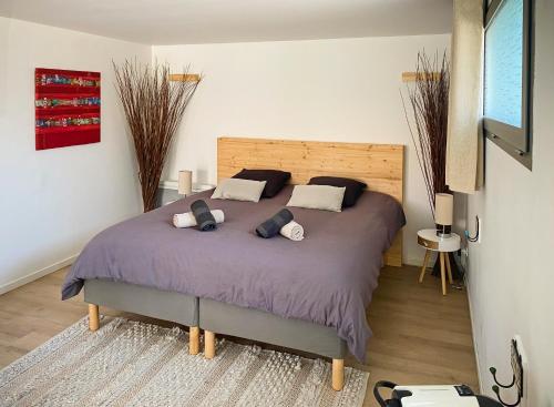 a bedroom with a large bed with two pillows at La Villa Hossegor in Hossegor