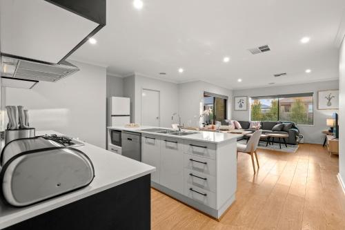 a kitchen and living room with a sink and a table at A Ballarat bliss in Alfredton