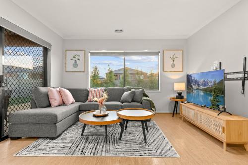 a living room with a couch and a table at A Ballarat bliss in Alfredton