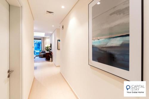 a hallway with a large painting on the wall at Capital Stay- Private Two Bed Apartment - The Address Beach Resort Residences Fujairah in Fujairah