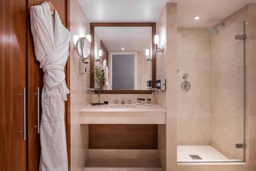 a bathroom with a sink and a shower at Warwick Grand-Place Brussels in Brussels
