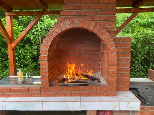 a brick oven with a fire in it at CASUTA MAGICA in Păuşeşti-Măglaşi