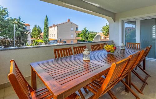 a wooden table and chairs on a balcony at Apartment Fucane Iv in Medulin
