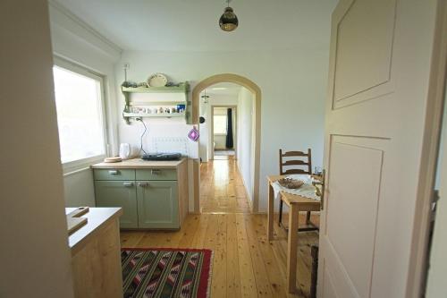 a kitchen with a table and a dining room at Vila Zora in Dobrna