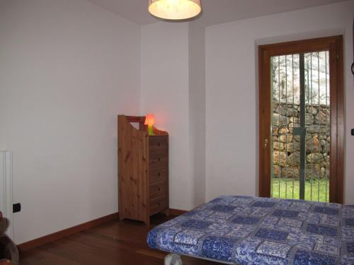 a bedroom with a bed and a dresser and a window at Apartment Adelaide by Interhome in Albisano