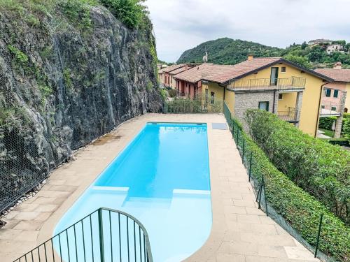 a swimming pool in front of a house at Apartment Adelaide by Interhome in Albisano