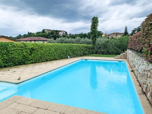 a large blue swimming pool in a yard at Apartment Adelaide by Interhome in Albisano