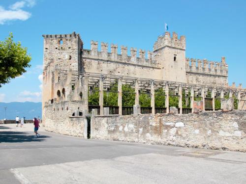 a castle with a person walking in front of it at Apartment Adelaide by Interhome in Albisano