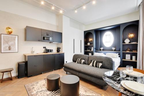 un salon avec un canapé et une table dans l'établissement Magnifique Studio Montorgueil, à Paris