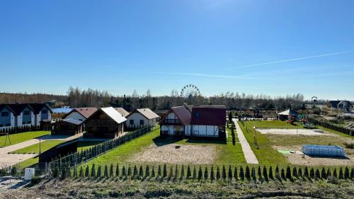 an aerial view of a village with houses and a fence at Bursztynowa Rosa & Wypożyczalnia rowerów elektrycznych in Łeba