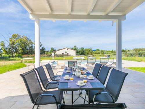 a blue table and chairs on a patio at Holiday Home Veronica by Interhome in Cecina