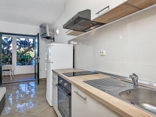 a kitchen with a sink and a refrigerator at Apartment Rubin-2 by Interhome in Zastražišće